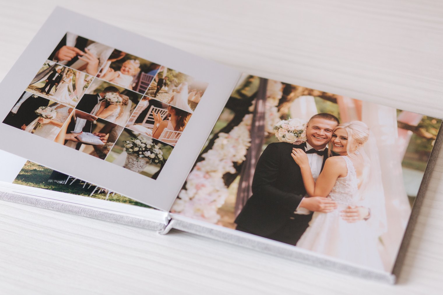 Open photobook with wrdding photo of beautiful couple on white wooden table